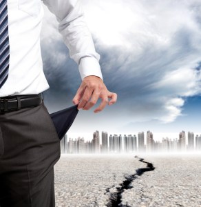 Business man showing his empty pockets and financial crisis concept